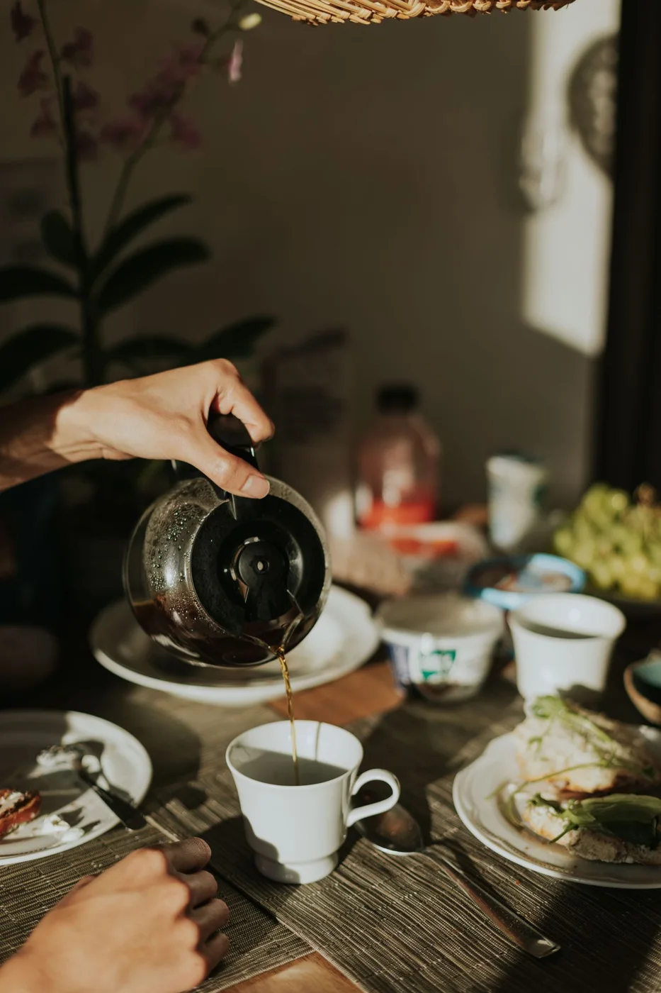Coffee and breakfast food arranged on a morning table
